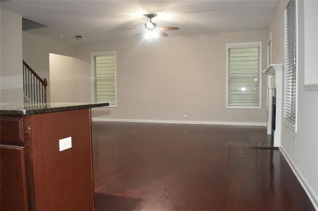 a kitchen with stainless steel appliances granite countertop a refrigerator a sink dishwasher a stove top oven a refrigerator and cabinets with wooden floor