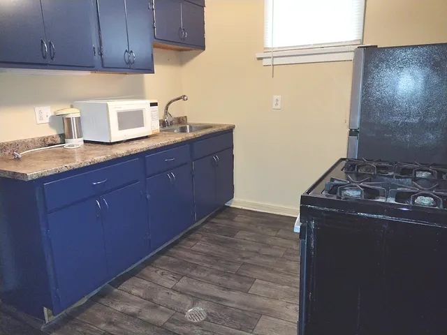 a kitchen with granite countertop a cabinets and a stove