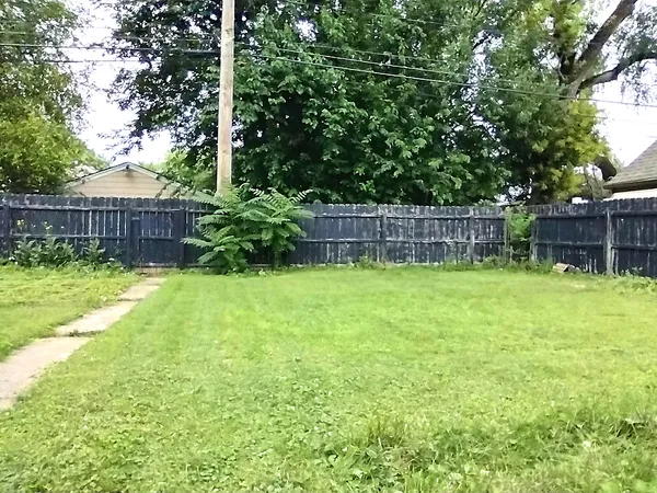 a view of a backyard with a small cabin and a chair