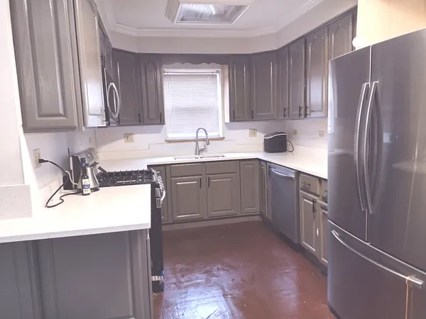 a kitchen with stainless steel appliances granite countertop a sink stove and refrigerator