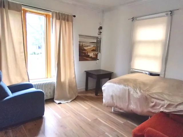 a bedroom with a bed and a couch
