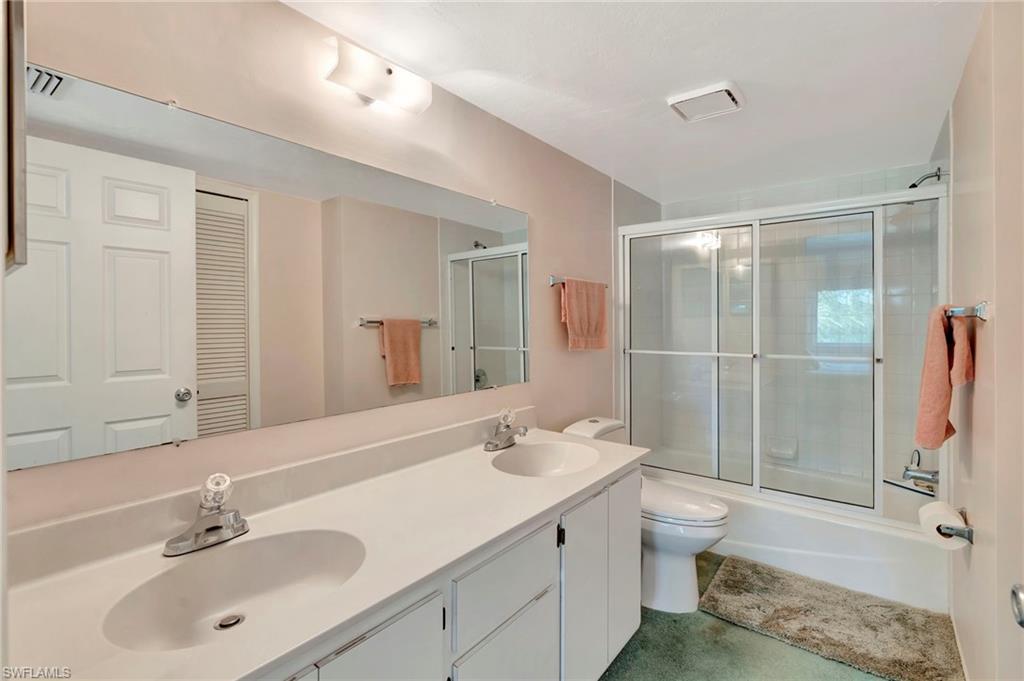 234 Pebble Beach Boulevard, Unit 305 Naples, FL 34113 - Photo 11 of 17 a bathroom with a sink shower and a mirror