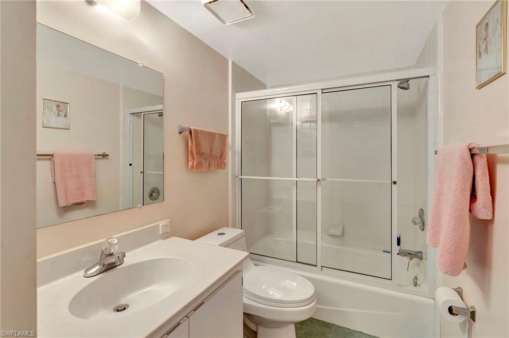 234 Pebble Beach Boulevard, Unit 305 Naples, FL 34113 - Photo 13 of 17 a bathroom with a sink toilet and shower