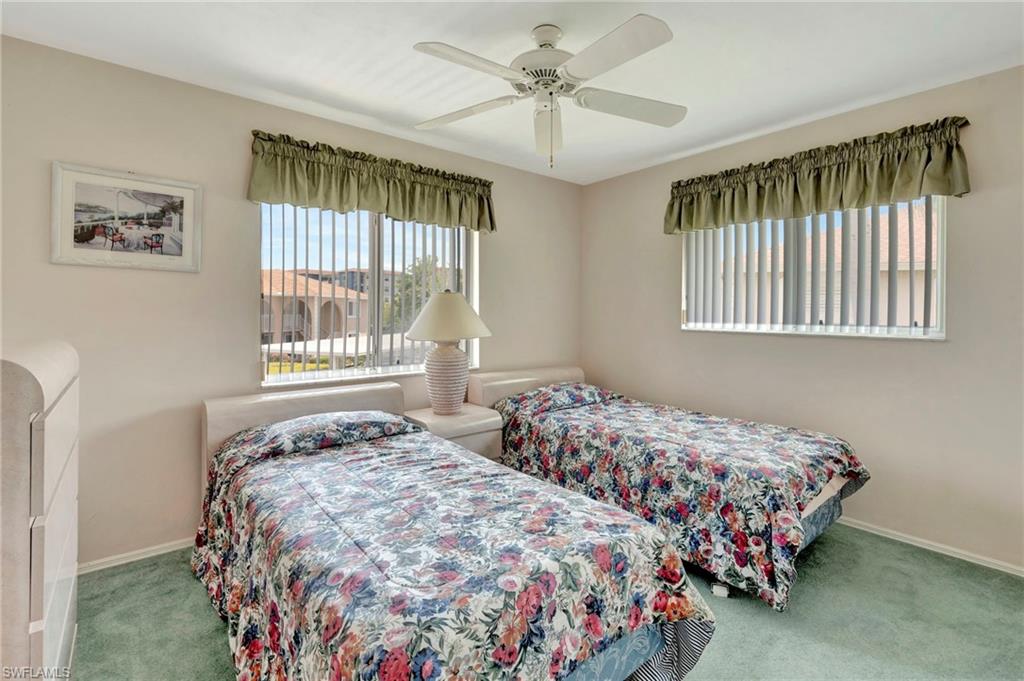 234 Pebble Beach Boulevard, Unit 305 Naples, FL 34113 - Photo 14 of 17 a bedroom with two beds and a window