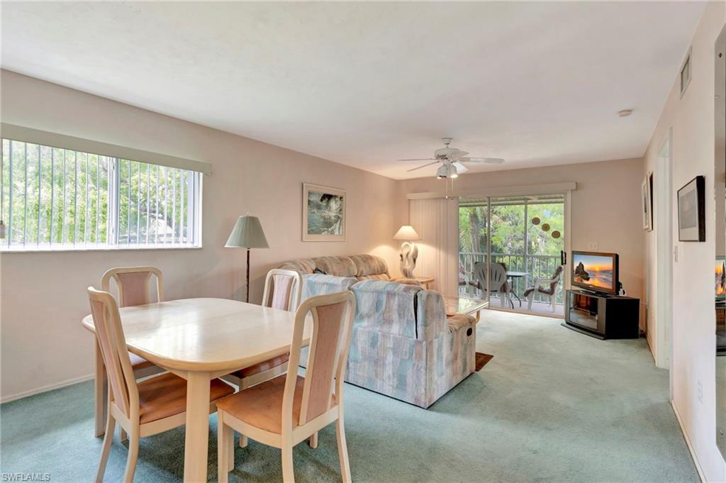234 Pebble Beach Boulevard, Unit 305 Naples, FL 34113 - Photo 5 of 17 a view of a dining room with furniture and a livingroom