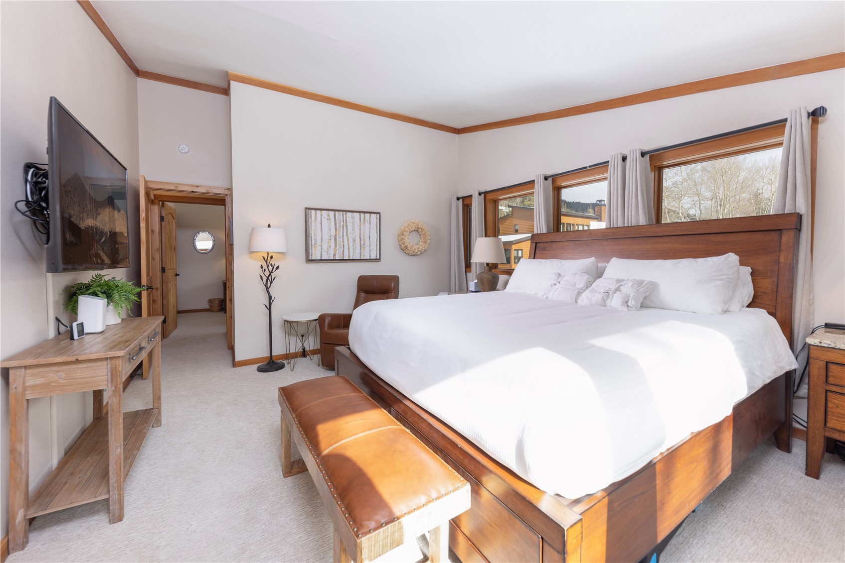 590 Tennis Club Road, Unit 1336 Keystone, CO 80435 - Photo 16 of 41 a spacious bedroom with a bed a mirror and a flat tv screen on dresser