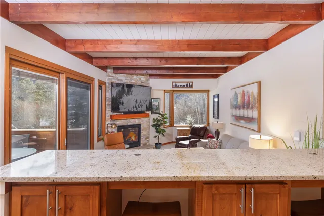 a kitchen with a granite countertop sink and large window