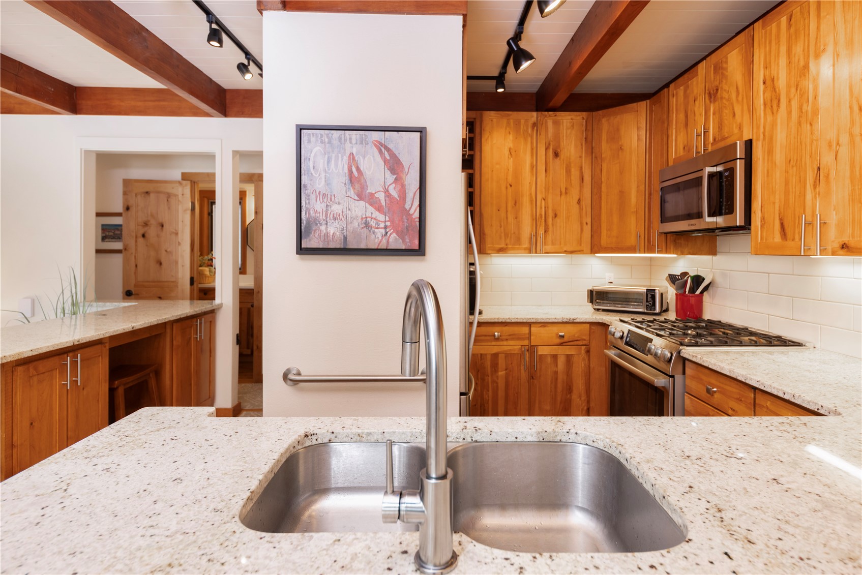 590 Tennis Club Road, Unit 1336 Keystone, CO 80435 - Photo 6 of 41 a kitchen with stainless steel appliances granite countertop a sink stove and cabinets