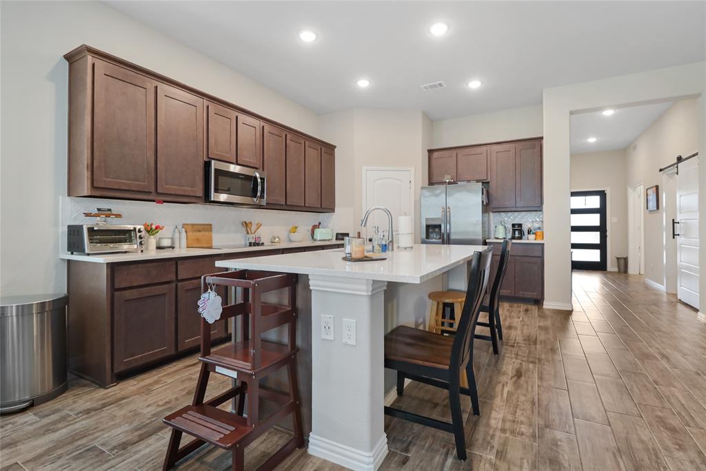 189 Chester Road Springtown, TX 76082 - Photo 12 of 29 a kitchen with a dining table chairs and refrigerator