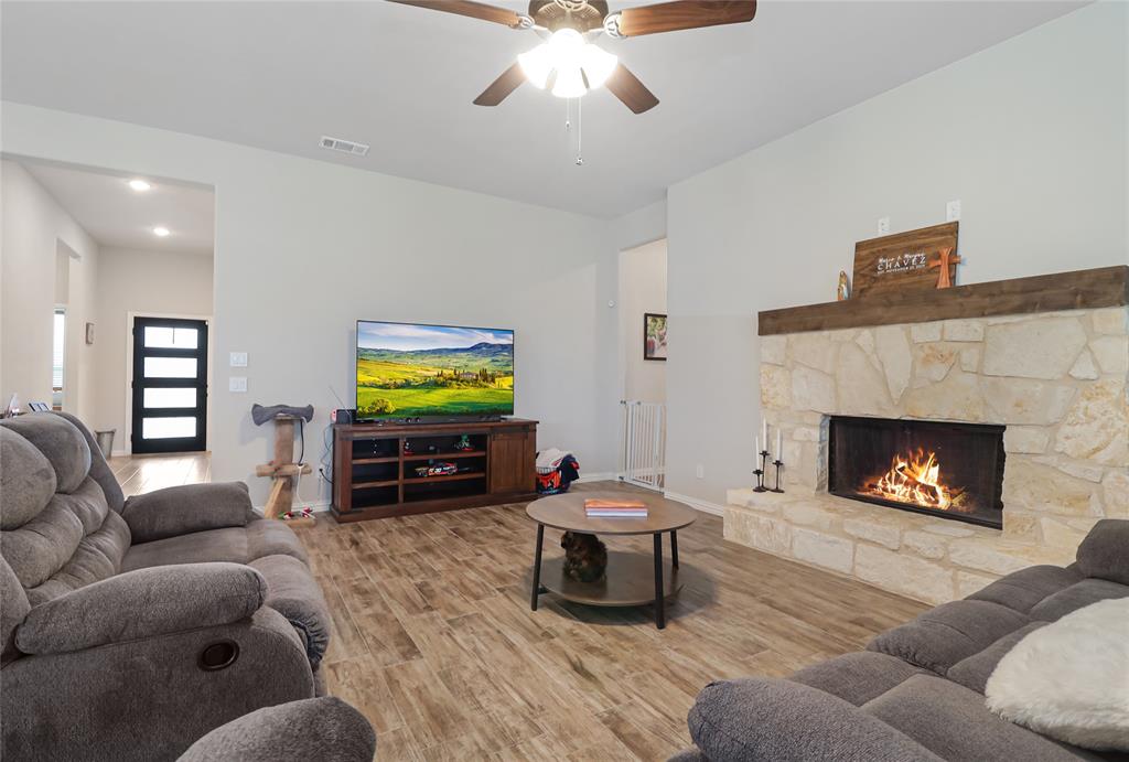 189 Chester Road Springtown, TX 76082 - Photo 16 of 29 a living room with furniture and a fireplace
