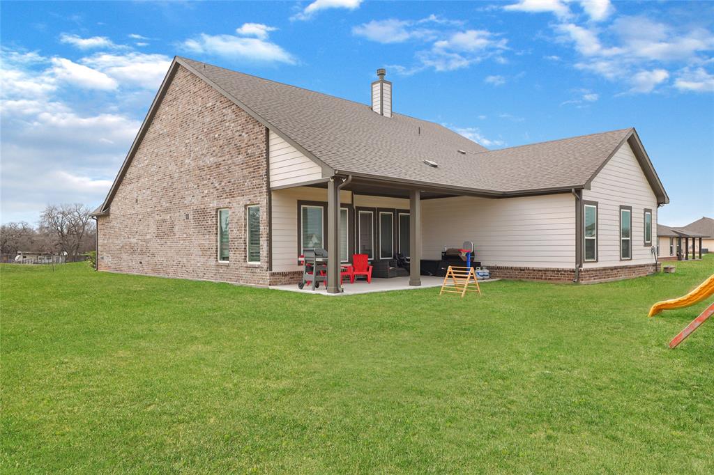 189 Chester Road Springtown, TX 76082 - Photo 29 of 29 a view of a house with a backyard and porch