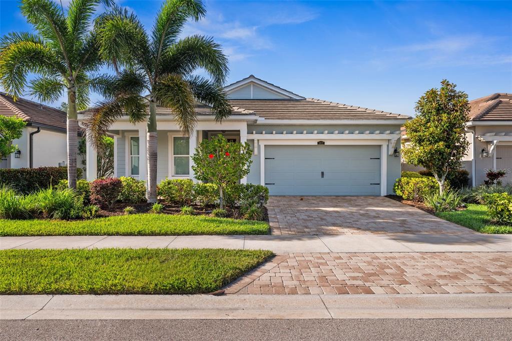 5632 Long Shore Loop Sarasota, FL 34238 - Photo 1 of 56 a front view of a house with a garden