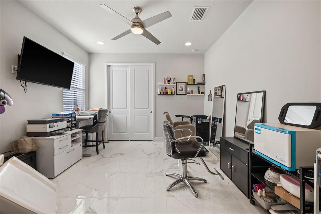 5632 Long Shore Loop Sarasota, FL 34238 - Photo 11 of 56 a view of a workspace with furniture and a flat screen tv