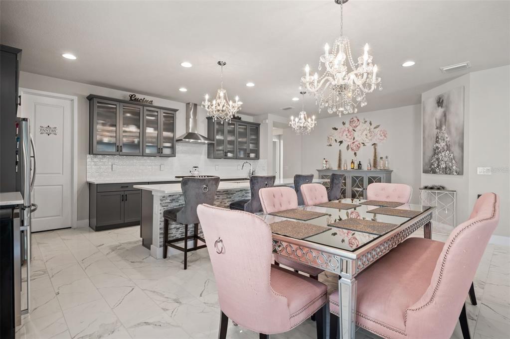 5632 Long Shore Loop Sarasota, FL 34238 - Photo 18 of 56 a dining room filled chandelier and kitchen view