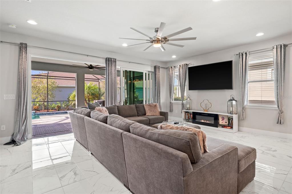 5632 Long Shore Loop Sarasota, FL 34238 - Photo 22 of 56 a living room with fireplace furniture and a flat screen tv