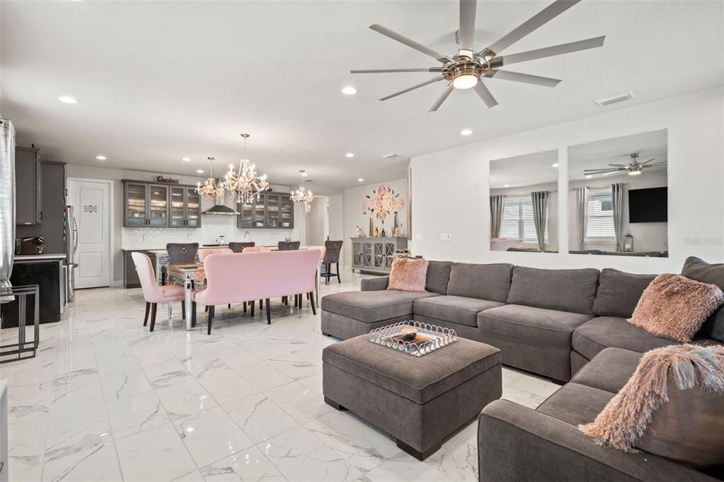 5632 Long Shore Loop Sarasota, FL 34238 - Photo 23 of 56 a living room with furniture kitchen view and a chandelier
