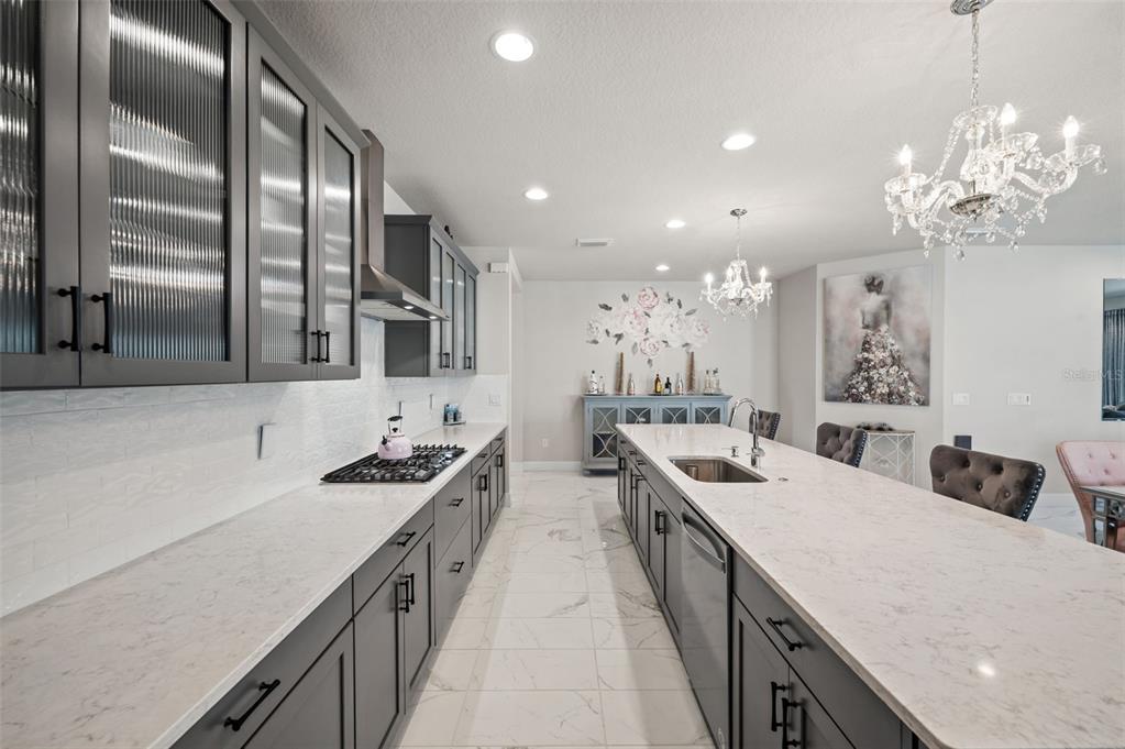 5632 Long Shore Loop Sarasota, FL 34238 - Photo 26 of 56 a kitchen with stainless steel appliances a sink dishwasher stove and refrigerator