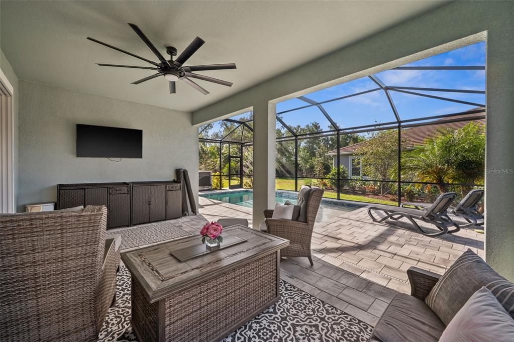 5632 Long Shore Loop Sarasota, FL 34238 - Photo 28 of 56 a living room with furniture a flat screen tv and a floor to ceiling window