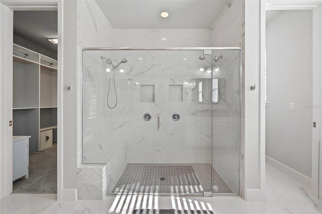 5632 Long Shore Loop Sarasota, FL 34238 - Photo 40 of 56 a bathroom with a glass shower door