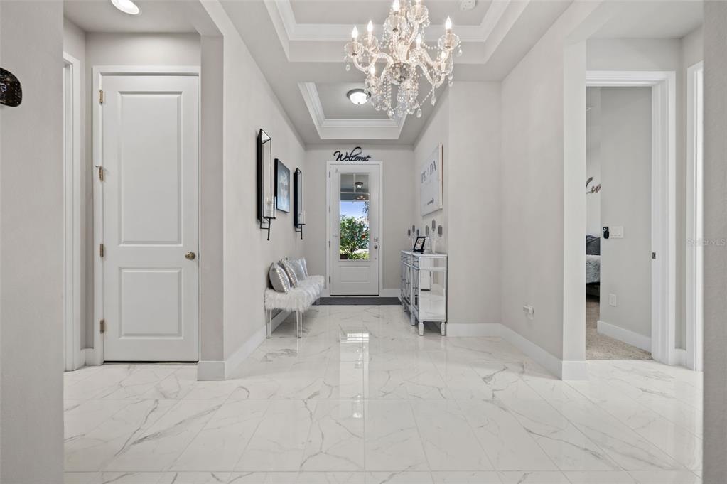 5632 Long Shore Loop Sarasota, FL 34238 - Photo 5 of 56 en empty room with white walls and chandelier