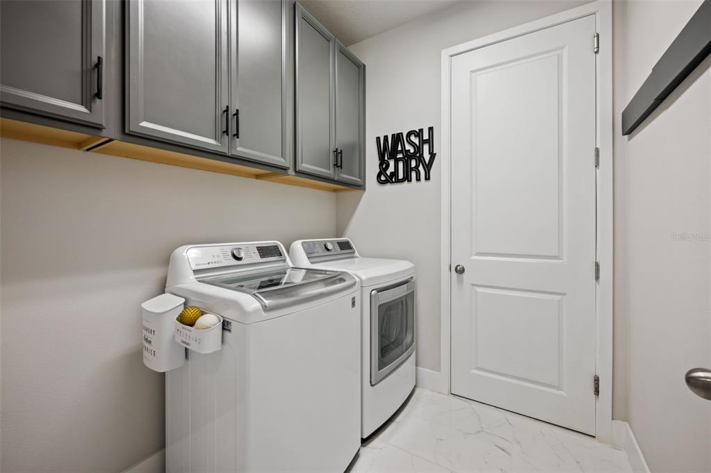5632 Long Shore Loop Sarasota, FL 34238 - Photo 7 of 56 a utility room with dryer and washer
