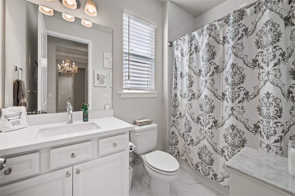 5632 Long Shore Loop Sarasota, FL 34238 - Photo 8 of 56 a bathroom with a sink toilet mirror and shower