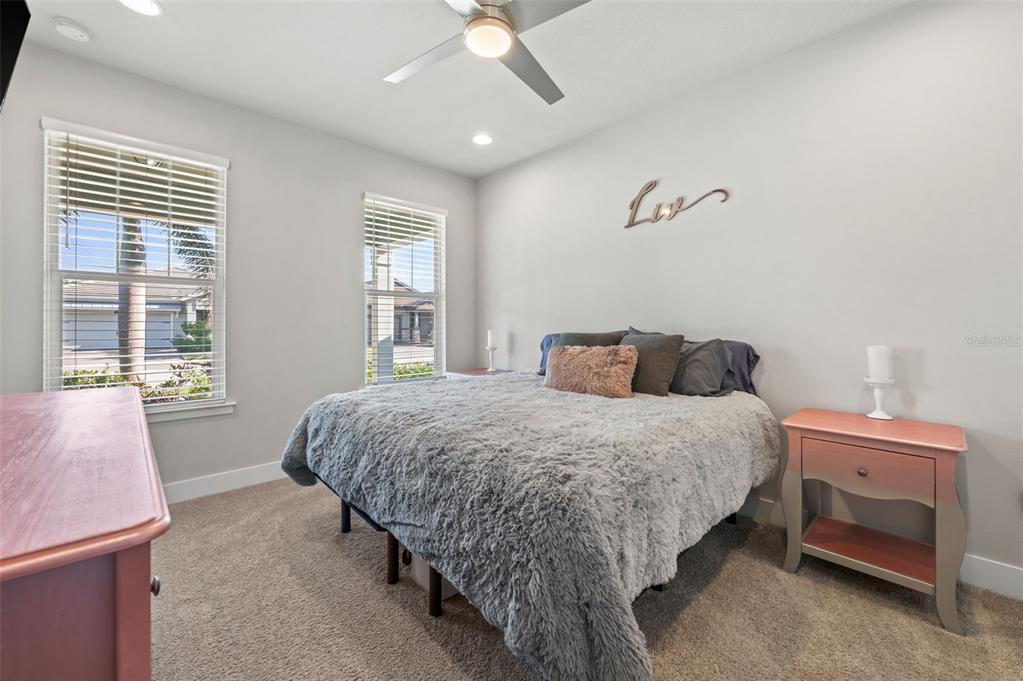 5632 Long Shore Loop Sarasota, FL 34238 - Photo 9 of 56 a bedroom with a bed and a chandelier