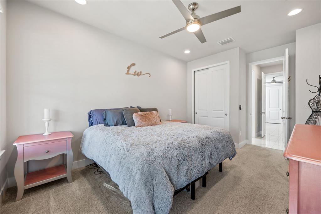 5632 Long Shore Loop Sarasota, FL 34238 - Photo 10 of 56 a bedroom with a bed and a couch