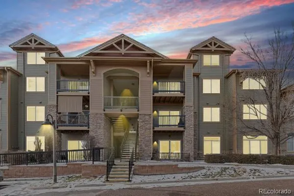 a front view of a residential apartment building with a yard