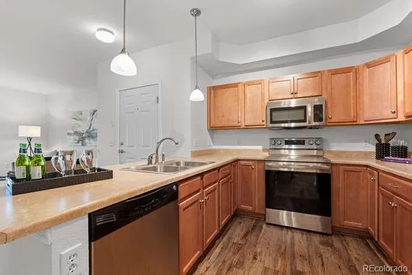 a kitchen with stainless steel appliances granite countertop a sink stove microwave and cabinets