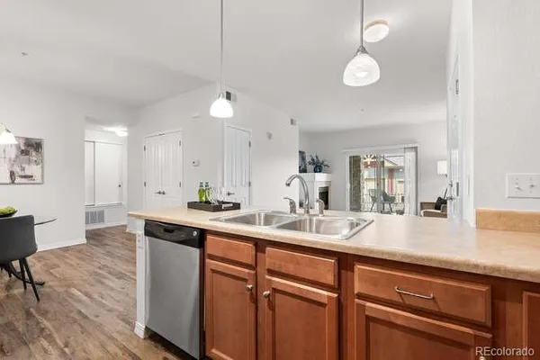 a kitchen with granite countertop stainless steel appliances a sink and cabinets