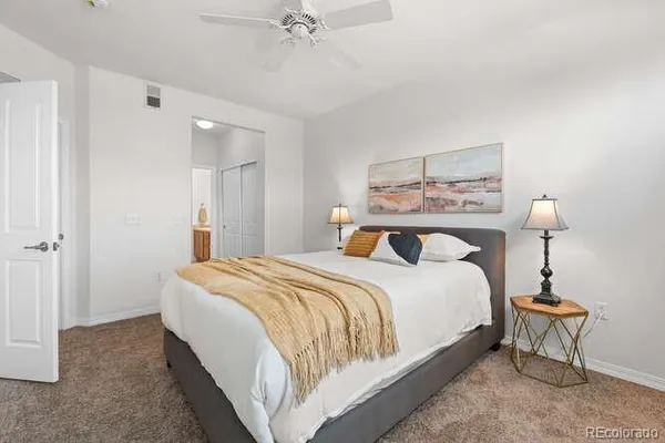 a bedroom with a bed a lamp and a window