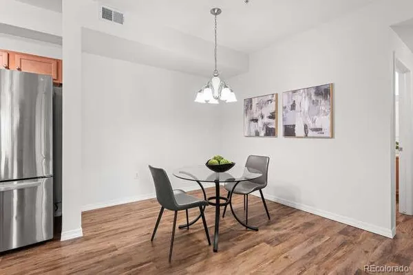 a view of a dining room with furniture wooden floor and a chandelier