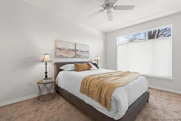 a large bed sitting in a bedroom next to a window