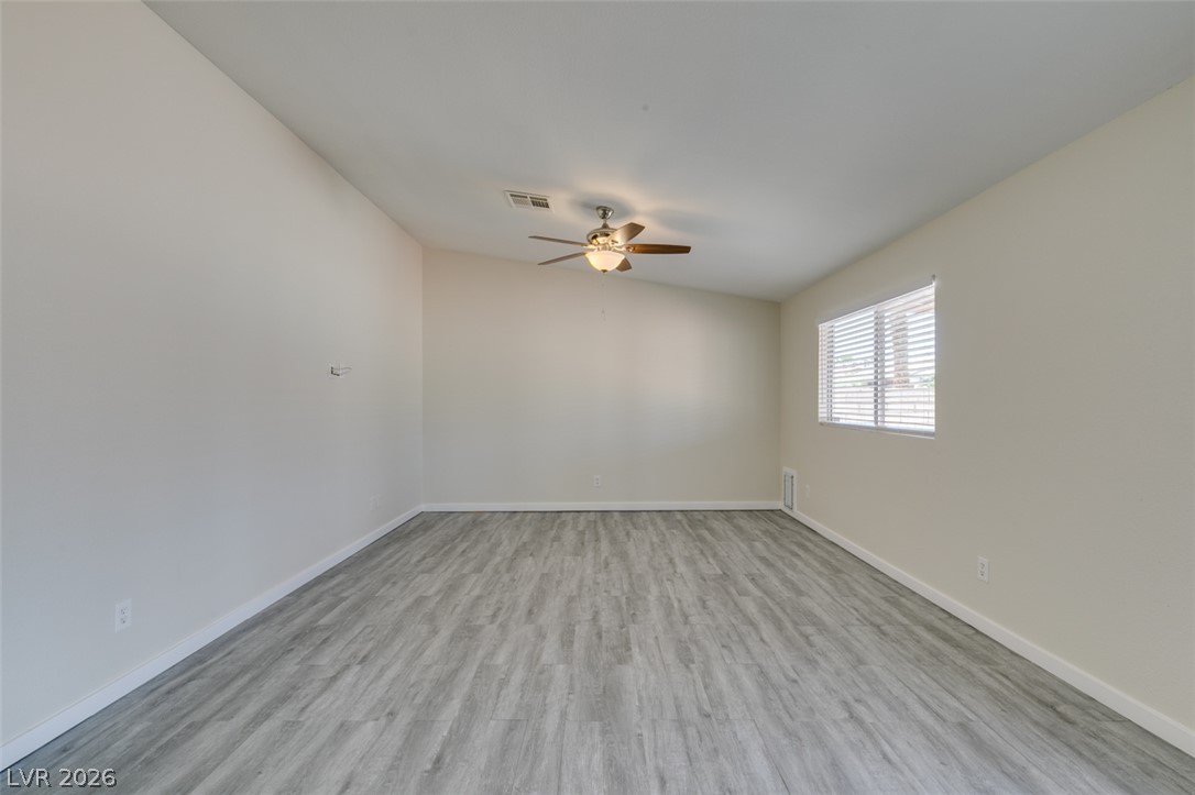 2028 Rustler Ridge Avenue North Las Vegas, NV 89031 - Photo 7 of 40 A well-lit, generous room featuring light-toned flooring and a window for natural light.