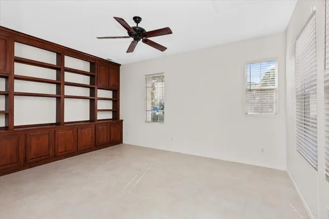 a view of room with window and ceiling fan