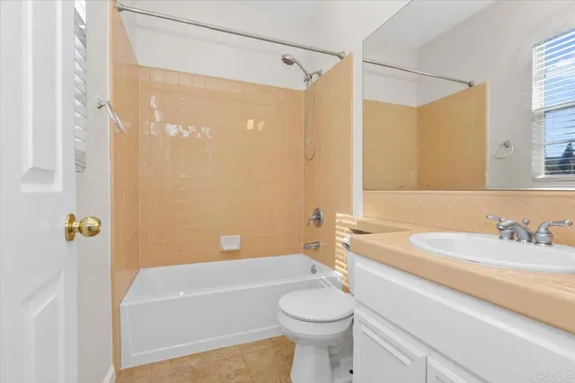 a bathroom with a sink a toilet a mirror a bathtub and shower