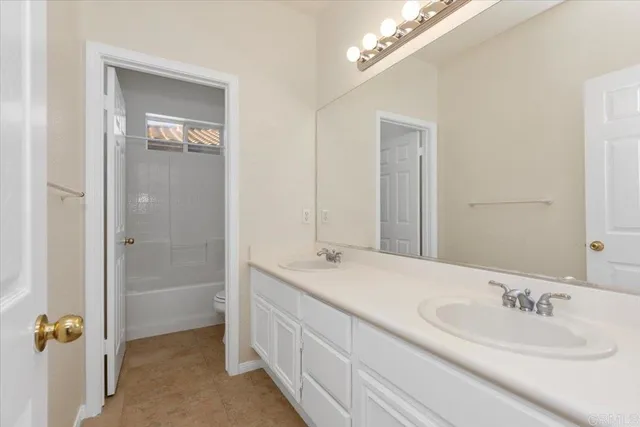 a bathroom with a double vanity sink a mirror and a shower