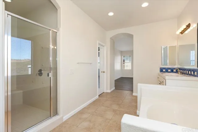 a view of a bathroom with tub and shower