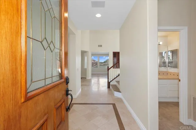 a view of a hallway with furniture and floor to ceiling window