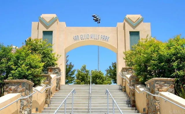 a view of a street with potted plants