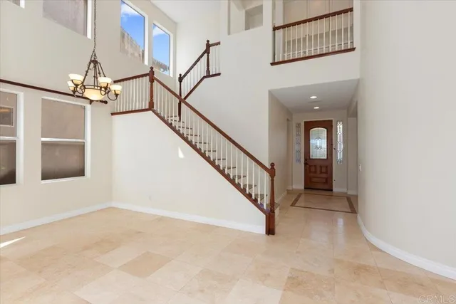 a view of staircase with railing and white walls