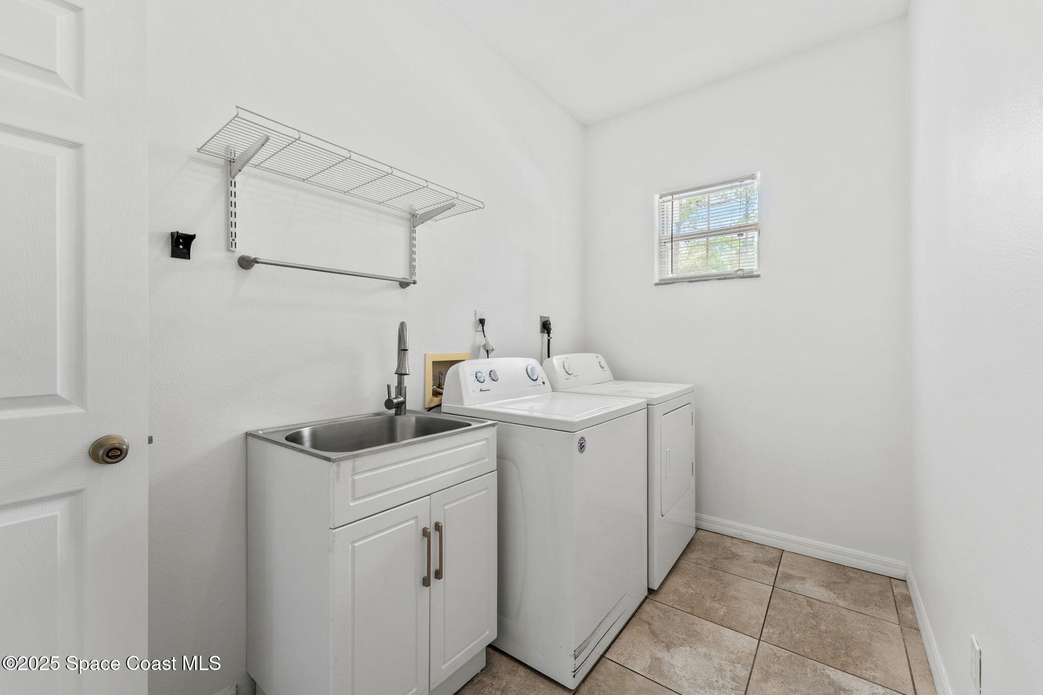 1385 Friday Road Cocoa, FL 32926 - Photo 11 of 33 a utility room with cabinets washer and dryer