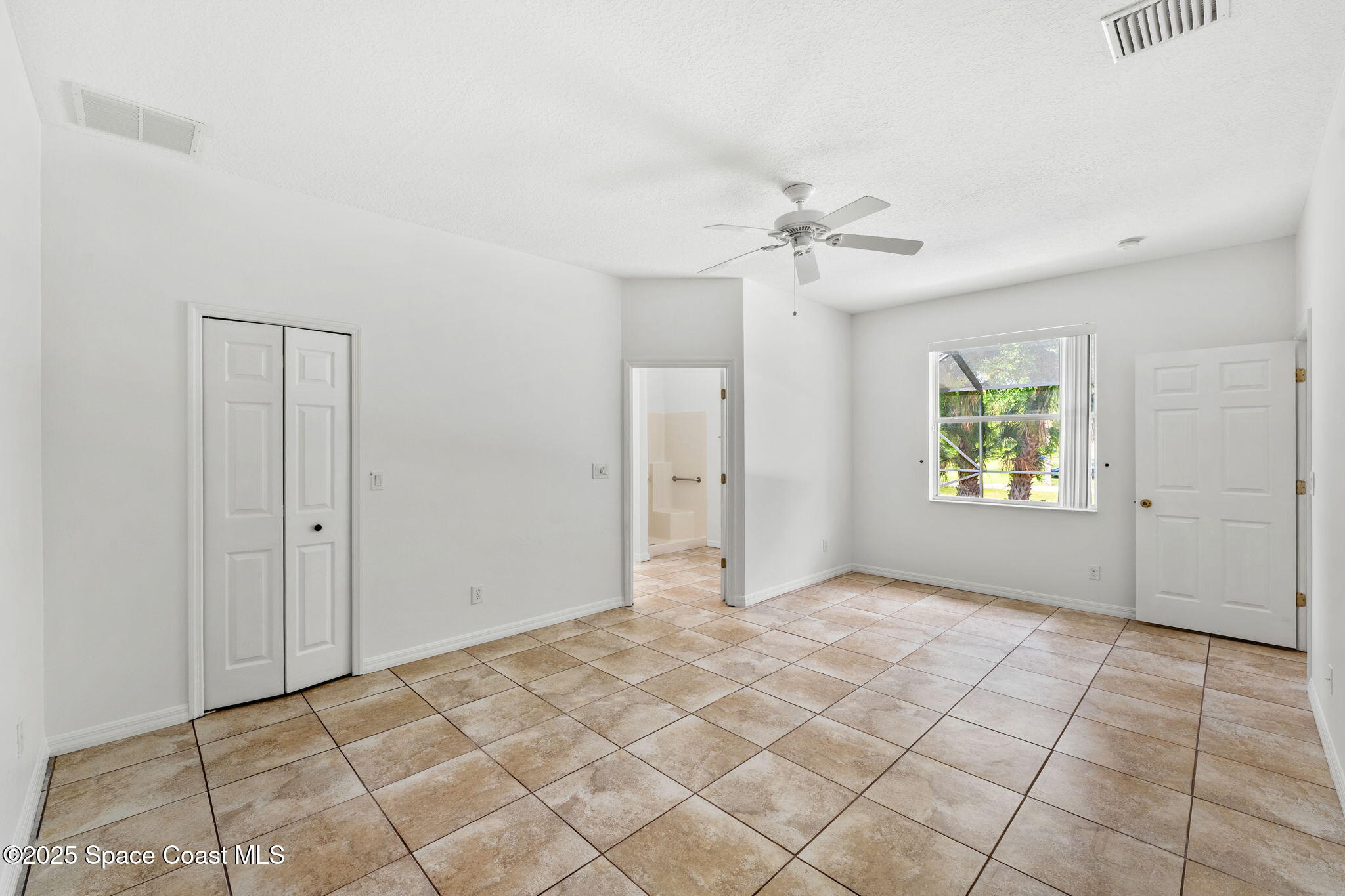 1385 Friday Road Cocoa, FL 32926 - Photo 13 of 33 an empty room with windows and fan