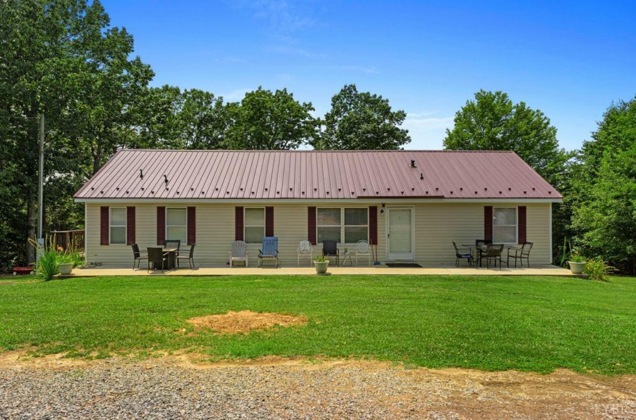 1362 Peaceful Ridge Road Huddleston, VA 24104 - Photo 1 of 19 a view of a swimming pool with lawn chairs and large trees