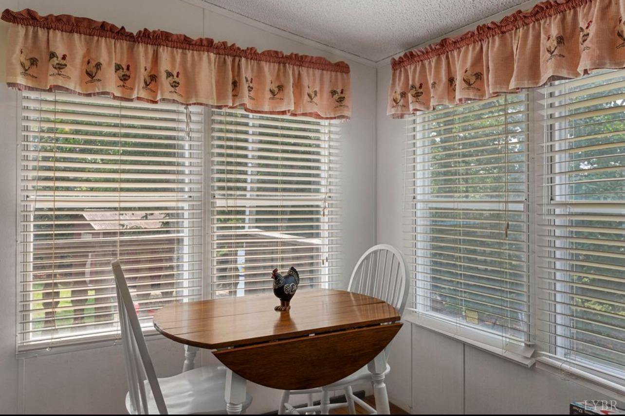 1362 Peaceful Ridge Road Huddleston, VA 24104 - Photo 13 of 19 a table and chairs in a balcony