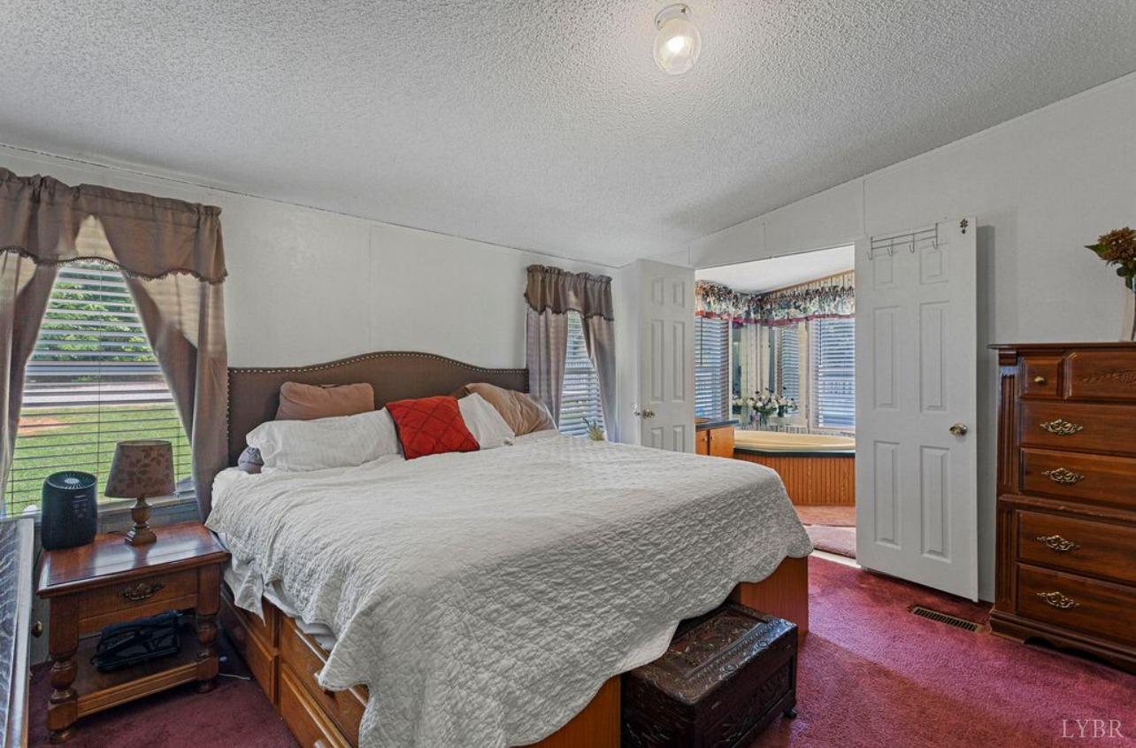 1362 Peaceful Ridge Road Huddleston, VA 24104 - Photo 17 of 19 a bedroom with a bed and wooden floor