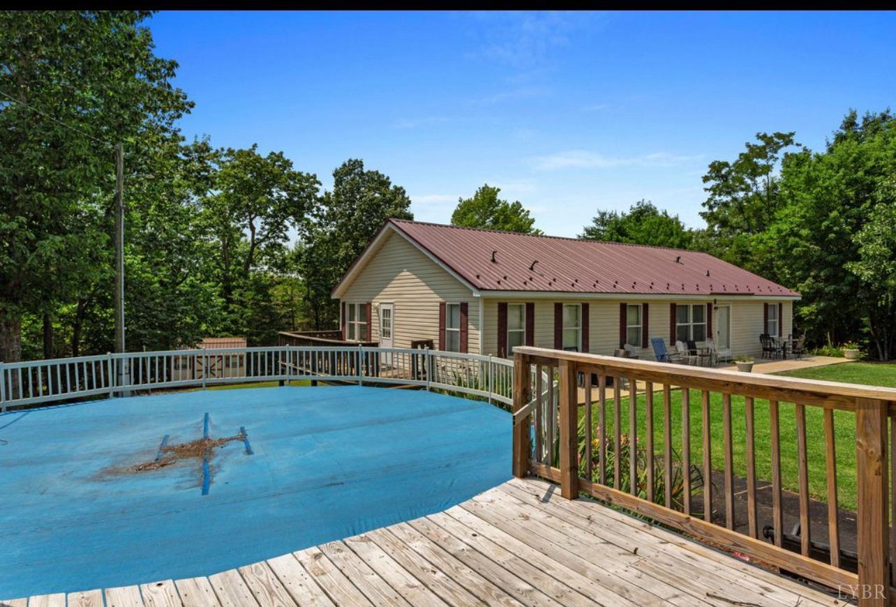 1362 Peaceful Ridge Road Huddleston, VA 24104 - Photo 2 of 19 a view of a house with wooden deck and furniture