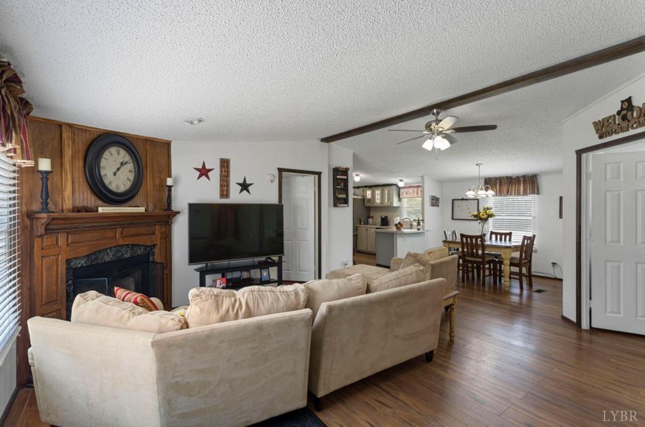 1362 Peaceful Ridge Road Huddleston, VA 24104 - Photo 3 of 19 a living room with furniture a fireplace and a flat screen tv