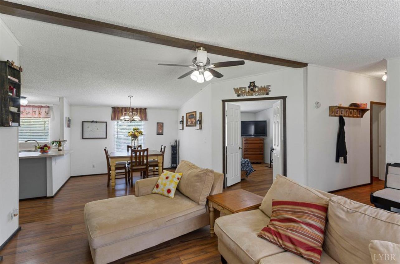 1362 Peaceful Ridge Road Huddleston, VA 24104 - Photo 4 of 19 a living room with furniture and a chandelier